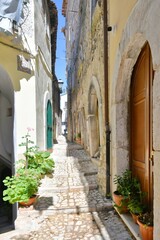 Fototapeta na wymiar A narrow street between the old houses of Guardia Sanframondi, a village in the province of Benevento, Italy. 