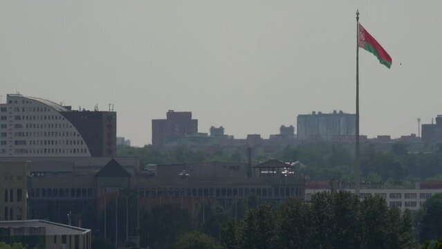 Minsk, Belarus. June 27, 2022. General view of the city. The national flag of the Republic of Belarus flutters against a gray sky.