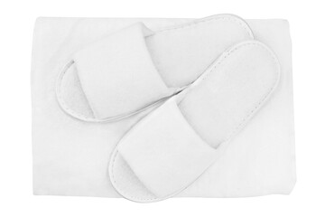 Spa, hotel, wellness, home pair of slippers with rolled towel isolated