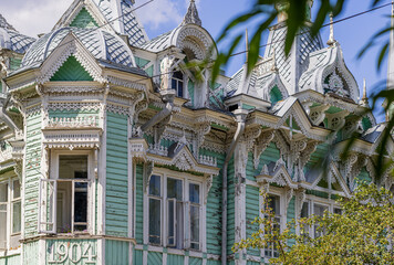 Carved wooden trim facade. Old historic house. Russian architecture. Chopped house with carved...
