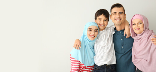 Obraz premium Portrait of happy Muslim family on light background with space for text