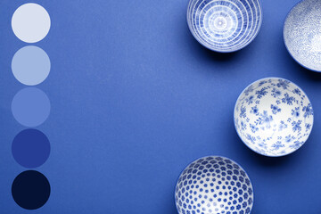 Beautiful Chinese bowls on blue background. Different color patterns