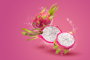 Water Splashing on Dragon Fruit or Pitaya over pink background.