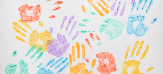 Colorful human palm prints on white background - obrazy, fototapety, plakaty