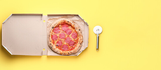 Box with tasty pepperoni  pizza and knife on yellow background with space for text