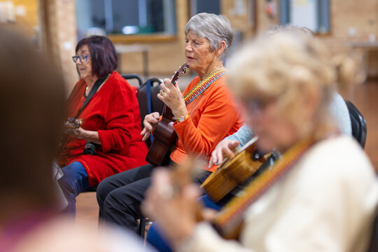 Group Of Senior Women Playing Ukulele