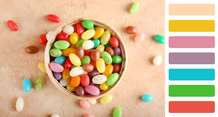 Bowl with sweet candies on beige background. Different color patterns