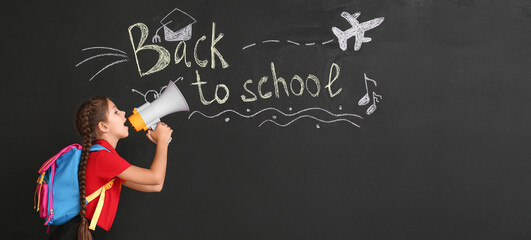 Cute girl with megaphone near blackboard with text BACK TO SCHOOL