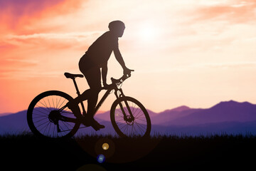 Silhouettes of mountain bikes and cyclists in the evening happily. Travel and fitness concept. .Silhouette of cyclists touring in the evening bicycle touring concept