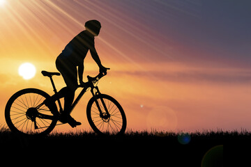 Silhouettes of mountain bikes and cyclists in the evening happily. Travel and fitness concept....