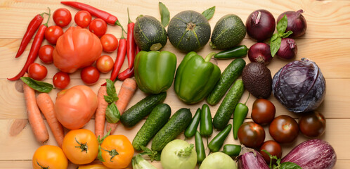 Assortment of fresh vegetables on wooden background