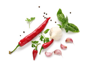 Composition with fresh chili peppers, garlic and herbs on white background