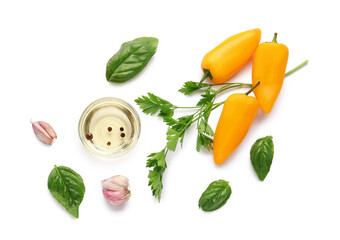 Composition with bowl of oil, bell peppers and herbs on white background