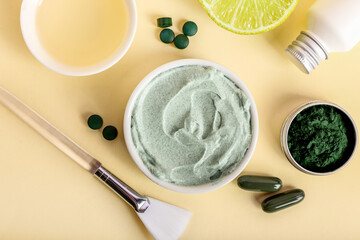 Composition with jar of spirulina facial mask and ingredients on color background
