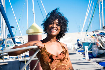 Tourist young black woman smile at the camera posing in summer holiday vacation. People and travel...