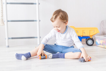 baby boy playing with wooden toys at home on the floor