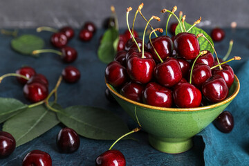 Bowl of ripe cherry on table