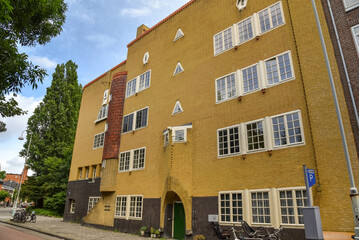 Fototapeta premium Amsterdam, Netherlands. June 2022. View of characteristic brick residential building in the style of the Amsterdam School in Spaarndammerbuurt, Amsterdam.