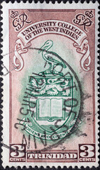 TRINIDAD - CIRCA 1951: a postage stamp from TRINIDAD , showing a bird on a coat of arms....