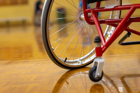 wheel of wheelchair with reflection on shiny floor
