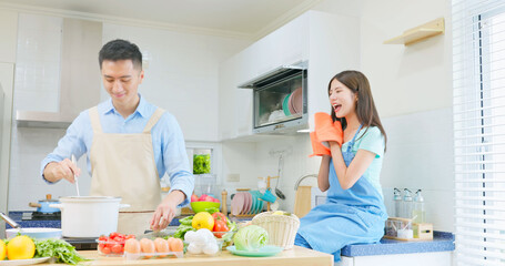 couple are cooking together