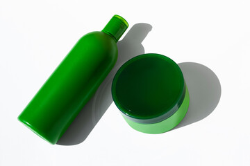 Green jar with care product. Hair mask and shampoos. Advertising of care products. Summer care for yourself and hair.
