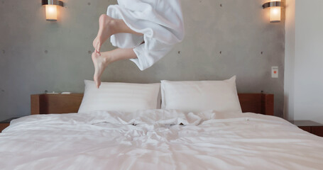 Excited woman jump with bathrobe