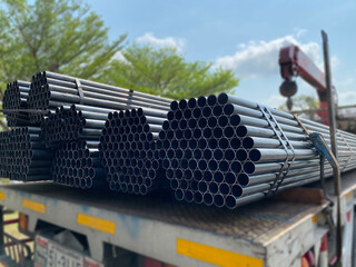high quality galvanized steel pipe or aluminum tubes and chrome stainless steel in piles waiting to be shipped in the warehouse.