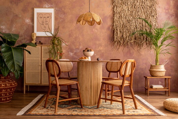 Stylish boho vintage dining room interior with poster mock up. Round table with rattan chair, commode and flowers. Brown wall and rattan lamp. Mock up poster. Template.