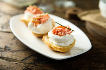 Homemade profiteroles with salmon and cream cheese