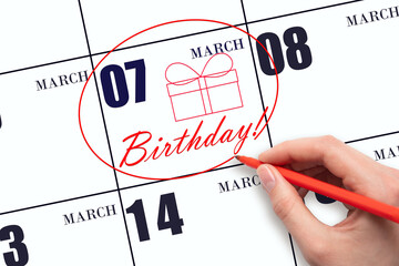 The hand circles the date on the calendar 7 March, draws a gift box and writes the text Birthday. Holiday.