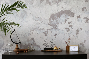 Fototapeta na wymiar Concrete interior of home office with copy space. Black desk, image, lamp and office accessories. Grey concrete wall. Home decor. Template.