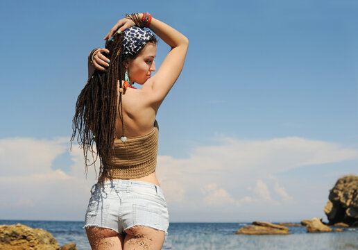 Woman back against sunny seascape