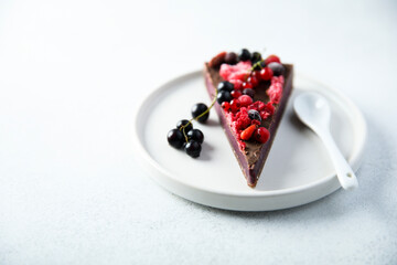 Homemade raw chocolate cake with berries