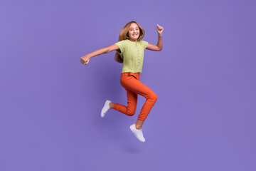 Fototapeta na wymiar Full length photo of excited sporty person jump run rush fast isolated on violet color background
