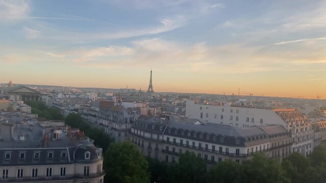 Paris city  and Eiffel Tower at sunset, 2022
High altitude view over Paris rooftops and Eiffel tower, sunset, 2022
