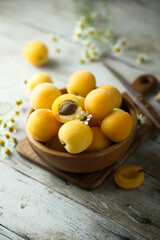Fresh ripe apricots in a wooden bowl