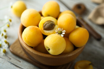 Fresh ripe apricots in a wooden bowl