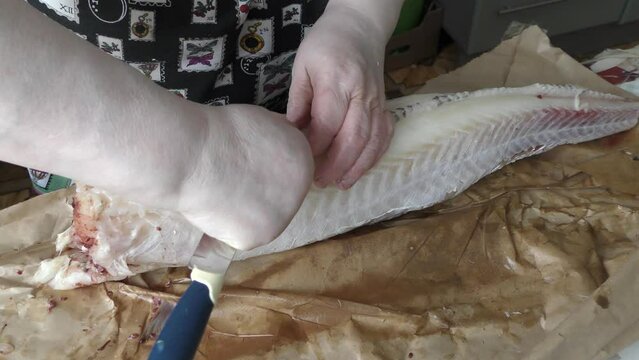 the cook cuts into pieces sea fish cod