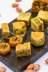 Varieties of pistachio baklava. Variety of baklava isolated on white background. Traditional Turkish cuisine delicacies. Desserts with pistachio syrup in the middle. close up