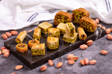 Varieties of pistachio baklava. Varieties of baklava on a dark background. Traditional Turkish cuisine delicacies. Desserts with pistachio syrup in the middle. close up
