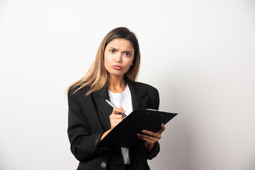 Business woman holding document on clipboard