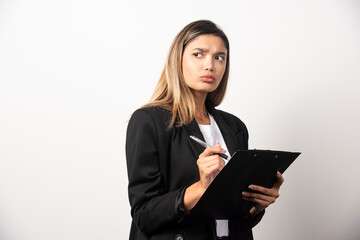 Businesswoman posing and holding clipboard