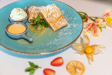 Apple strudel with honey and ice cream and fresh berries