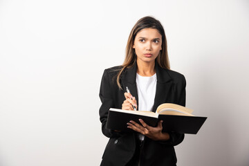 Young businesswoman holding an opened clipboard with pencil