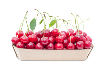 Cardboard container filled with red cherries on a white background