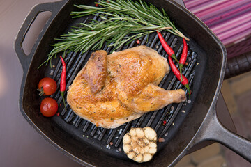 char-grilled chicken, with rosemary, tomato, hot pepper, garlic, green in pan grill