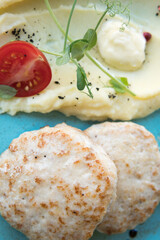 Mashed potatoes with beef patty and tomato