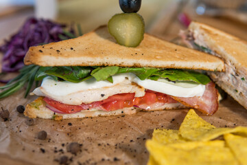 Chicken and bacon sandwich, with tomatoes, pickles, olives