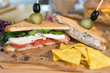 Chicken and bacon sandwich, with tomatoes, pickles, olives